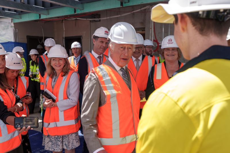 King Charles III speaking with workers at the Glebe development